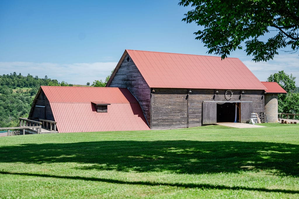 The Barn on Hubbard in Callicoon, NY with red roofs and open green hills—an ideal backdrop for a wedding weekend in the Catskills.
