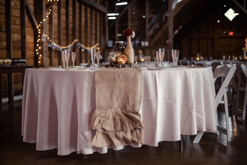 Rustic barn wedding reception setup showcasing why fall is the best season to get married.