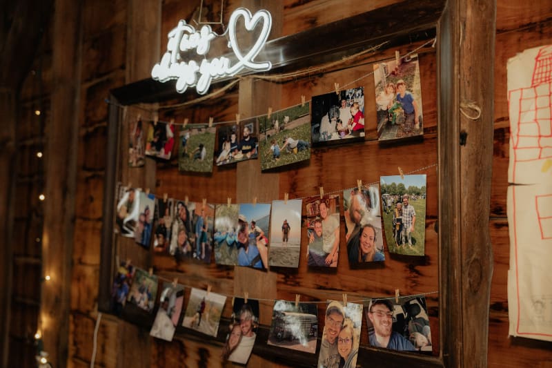 Personal photo display with snapshots clipped to string beneath a glowing “I Love You” sign.